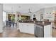 Open-concept kitchen with stainless steel appliances and dining area, seamlessly blending indoor and outdoor living at 927 River Basin Ct # 201C, Bradenton, FL 34212