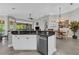Open kitchen, stainless steel appliances, breakfast bar, adjacent to dining area with lanai views at 927 River Basin Ct # 201C, Bradenton, FL 34212