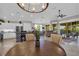 Open-concept living room with a kitchen, dining area, and access to the screened balcony at 927 River Basin Ct # 201C, Bradenton, FL 34212