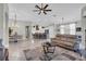 Open-concept living room with a kitchen island, dining area, and comfortable seating with views to the balcony at 927 River Basin Ct # 201C, Bradenton, FL 34212