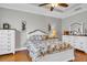 Spacious main bedroom featuring hardwood floors, a tray ceiling, and white dressers at 927 River Basin Ct # 201C, Bradenton, FL 34212