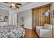 Comfortable main bedroom features a ceiling fan and sitting area at 927 River Basin Ct # 201C, Bradenton, FL 34212