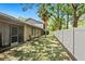 Spacious backyard featuring lush green grass, a privacy fence, and shady trees offering a peaceful outdoor space at 928 Sunridge Dr # F2, Sarasota, FL 34234