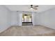 Neutral bedroom with ceiling fan and sliding doors leading to screened-in outdoor living space at 928 Sunridge Dr # F2, Sarasota, FL 34234