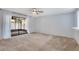 Spacious bedroom with neutral carpet, ceiling fan, and large sliding doors leading to screened patio at 928 Sunridge Dr # F2, Sarasota, FL 34234