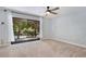 Inviting bedroom featuring sliding glass doors, ceiling fan and great natural lighting at 928 Sunridge Dr # F2, Sarasota, FL 34234