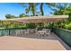 Community deck with an outdoor covered area, including dining tables and chairs for residents at 928 Sunridge Dr # F2, Sarasota, FL 34234