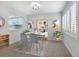 Cozy dining room featuring modern lighting and decor adjacent to the kitchen at 928 Sunridge Dr # F2, Sarasota, FL 34234