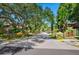 A welcoming view down the main drive into Sunridge Condominiums, showcasing lush landscaping at 928 Sunridge Dr # F2, Sarasota, FL 34234
