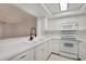 Bright kitchen featuring white appliances, cabinets, and stylish backsplash at 928 Sunridge Dr # F2, Sarasota, FL 34234
