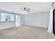 Open-concept living room with a view of the kitchen and sliding glass doors to the patio at 928 Sunridge Dr # F2, Sarasota, FL 34234