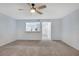Neutral living room with view to a modern white kitchen and recessed lighting at 928 Sunridge Dr # F2, Sarasota, FL 34234