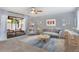 Bright living room with stylish furniture, ceiling fan, and sliding doors to outdoor space at 928 Sunridge Dr # F2, Sarasota, FL 34234