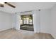 Screened-in patio is seen from a bright bedroom with neutral walls and neutral carpet at 928 Sunridge Dr # F2, Sarasota, FL 34234