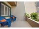 Cozy patio with blue wicker chairs and potted plants, perfect for relaxing outdoors at 928 Sunridge Dr # F2, Sarasota, FL 34234
