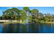 Beautiful lake view featuring a fountain with a rainbow effect, surrounded by lush greenery at 928 Sunridge Dr # F2, Sarasota, FL 34234
