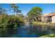 Scenic pond view with fountains surrounded by lush greenery and mature trees at 928 Sunridge Dr # F2, Sarasota, FL 34234
