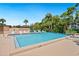 Relaxing community pool with plenty of lounge seating surrounded by lush landscaping and well-maintained grounds at 928 Sunridge Dr # F2, Sarasota, FL 34234