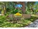 Community sign for Sunridge Condominiums, surrounded by lush greenery and colorful flowers at 928 Sunridge Dr # F2, Sarasota, FL 34234