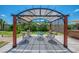 Backyard featuring covered dining area with seating for six and views of the home's landscaping at 9321 New Martinsville Ave, Englewood, FL 34224