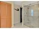Bathroom featuring a glass shower door with marble tiling, built-in shower niche, and a closet at 9321 New Martinsville Ave, Englewood, FL 34224