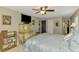 Bright bedroom with a flat screen tv on a dresser with decorative mirror and adjacent closet at 9321 New Martinsville Ave, Englewood, FL 34224