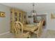 Elegant dining room with display cabinet, table, and shiplap wall detail at 9321 New Martinsville Ave, Englewood, FL 34224