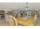 Open floorplan dining room connects to the kitchen and features elegant dining furniture at 9321 New Martinsville Ave, Englewood, FL 34224