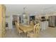 The dining room is adjacent to a modern kitchen with stainless steel appliances at 9321 New Martinsville Ave, Englewood, FL 34224