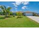 Charming home with a well manicured lawn, lush landscaping, and a two car garage in a lovely neighborhood at 9321 New Martinsville Ave, Englewood, FL 34224