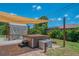 Backyard with a covered hot tub and patio area, surrounded by lush greenery at 9321 New Martinsville Ave, Englewood, FL 34224