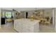 Bright kitchen with large island, eat-in dining area, and open living space filled with natural light at 9321 New Martinsville Ave, Englewood, FL 34224