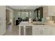Kitchen sink featuring bright windows and a workspace with white cabinets and stainless appliances at 9321 New Martinsville Ave, Englewood, FL 34224