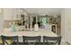 Bright kitchen featuring white cabinets, stainless steel appliances, and a central island with seating at 9321 New Martinsville Ave, Englewood, FL 34224