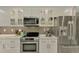 Updated kitchen featuring stainless steel appliances, white cabinets, and a modern design at 9321 New Martinsville Ave, Englewood, FL 34224