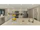 The contemporary kitchen features stainless appliances, white cabinetry, and a marble island at 9321 New Martinsville Ave, Englewood, FL 34224