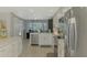 Modern kitchen boasts stainless appliances, white cabinetry, and a bright eating space with large windows at 9321 New Martinsville Ave, Englewood, FL 34224