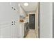 Laundry room features stainless steel appliances, white cabinets, and overhead lighting at 9321 New Martinsville Ave, Englewood, FL 34224