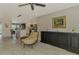 Open living area with light wood floors, leading to a modern kitchen with a white island at 9321 New Martinsville Ave, Englewood, FL 34224