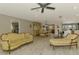 Spacious living room flows into the dining area, featuring light wood floors and neutral decor at 9321 New Martinsville Ave, Englewood, FL 34224