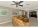 Comfortable living room with a beige couch, decorative artwork, and lots of natural light at 9321 New Martinsville Ave, Englewood, FL 34224