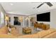 Open-concept living room featuring modern decor, tile floors, and a large-screen television at 9321 New Martinsville Ave, Englewood, FL 34224