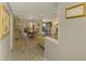Spacious living space featuring beautiful tile flooring, neutral walls, and access to the kitchen and dining area at 9321 New Martinsville Ave, Englewood, FL 34224