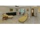 Elegant living space featuring an oversized window, neutral colors, and lovely furnishings at 9321 New Martinsville Ave, Englewood, FL 34224