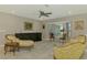 Bright living space with lovely seating, tile floors, neutral walls, and an oversized picture window at 9321 New Martinsville Ave, Englewood, FL 34224
