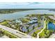 Aerial view of the community amenities including a pool, clubhouse, and lake at 1007 Waterline Ct, Sarasota, FL 34240