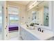 Modern bathroom with double sinks, quartz countertops, frameless glass shower, and views into the Primary bedroom at 1007 Waterline Ct, Sarasota, FL 34240