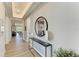 Bright entryway with decorative mirror and console table with views of the living room at 1007 Waterline Ct, Sarasota, FL 34240