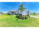 Beautiful single-story home boasts a well-manicured lawn, tropical landscaping, and a charming two-car garage at 1007 Waterline Ct, Sarasota, FL 34240