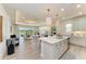 Open kitchen with large center island and modern lighting fixtures overlooking the bright living area at 1007 Waterline Ct, Sarasota, FL 34240